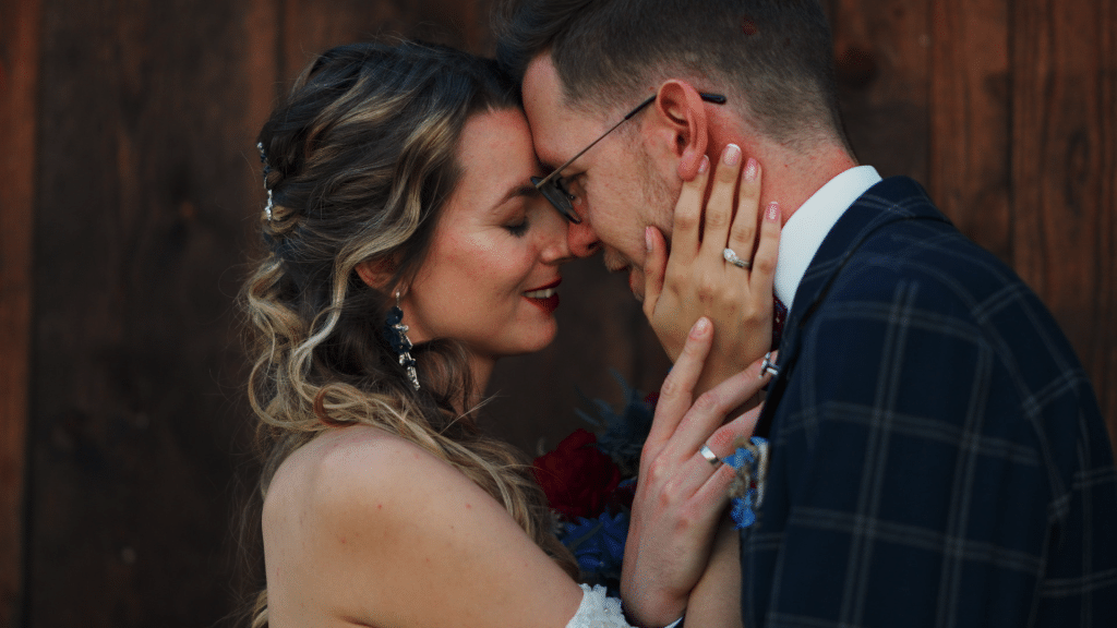 a man and woman holding each other's faces